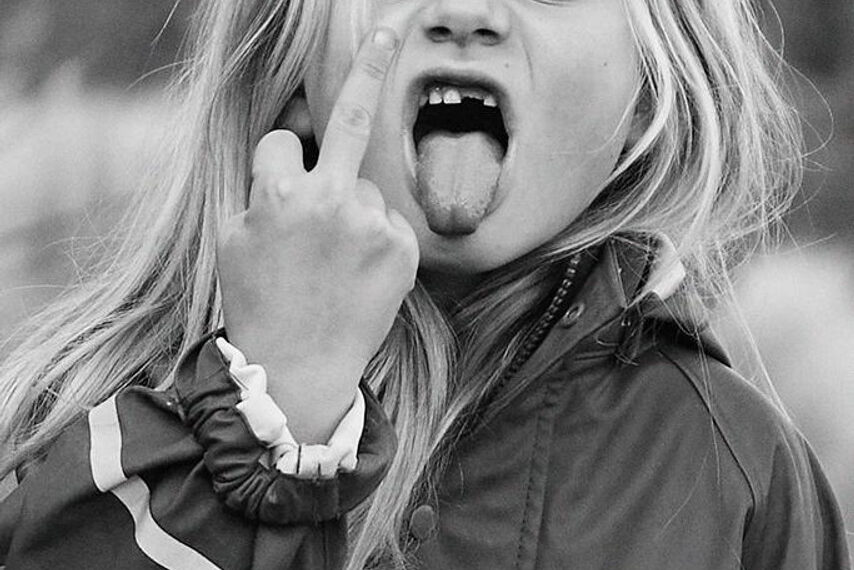 vintage image of young girl giving the finger and sticking her tongue out