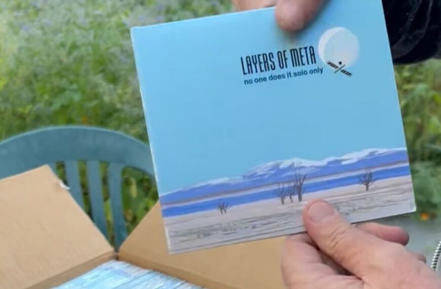 A still shot from the video showing me holding the very first CD from the batch to be opened.